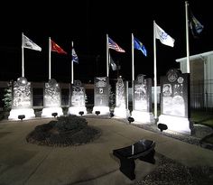 a group of flags flying in the air next to tombstones