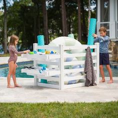 two children are playing near the pool