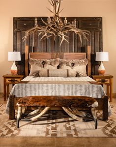 a bed with antlers on the headboard and foot board