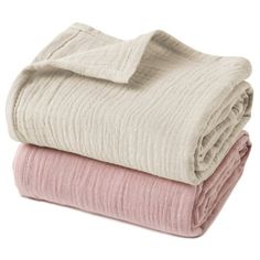 two blankets stacked on top of each other in pink and beige colors, one folded over the