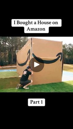 a man kneeling down in front of a cardboard box with an amazon logo on it