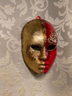 Original Venetian papier-mache mask made entirely by hand and hand-decorated with acrylic colors. It can be worn through laces or used as a decoration of the house. Being handmade each piece is unique. All our masks are handmade by our staff (me, my wife and our collaborators) in our atelier in Venice. The masks are all made of paperweight and are made using ancient techniques from the 1300s They are decorated with acrylic colors, gold leaf, silver leaf, trifies, lace and Swarovski crystals so a Artistic Red Masks And Prosthetics For Festivals, Artistic Red Masks And Prosthetics For Mardi Gras, Artistic Red Masks And Prosthetics For Theater, Traditional Red Masks And Prosthetics For Costume, Traditional Red Costume Masks And Prosthetics, Artistic Red Mask For Costume, Red Full Face Carnival Mask, Red Full Face Mask For Carnival, Handmade Red Masquerade Mask