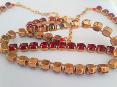 "Handcrafted Ruby Antique Gold Double Layer crystal necklace made with Authentic Swarovski Elements. Ruby Red Swarovski Chatons 8mm 1028 SS29 Metal type: Antique Gold plated High Quality setting. Nickel & Leaf free metal setting. Length: 16\" - 18\" plus 2\" adjustable chain extender. All costume jewelry need special treatment, therefore handle with care and avoid water, shampoo or perfume. Similar Style: Antique style. *MORE NECKLACE STYLES: https://www.etsy.com/shop/ParisiJewelryDesigns?re Antique Copper Jewelry, Necklace Gold Jewelry, Red Crystal Necklace, Necklace Styles, Red Choker, Antique Gold Jewelry, Swarovski Stones, Swarovski Necklace, Deco Engagement Ring