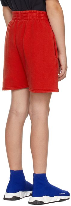 Cotton fleece shorts in red featuring logo printed in white at front. · Two-pocket styling · Elasticized waistband · Machine wash Model measures 51” / 129.5 cm tall and wears size 8. Supplier color: Bright red Size: child's height 2: 35.75 / 91 cm 4: 41.25 / 105 cm 6: 46.75 / 118.5 cm 8: 52.25 / 132.5 cm 10: 55.35 / 140.5 cm Red Cotton Sporty Bottoms, Red Shorts With Elastic Waistband For Loungewear, Red Loungewear Shorts With Elastic Waistband, Red Elastic Waistband Shorts For Loungewear, Red Streetwear Shorts, Red Short Bottoms For Streetwear, Red Shorts With Side Pockets, Red Short Length Bottoms For Streetwear, Sporty Red Shorts For Loungewear