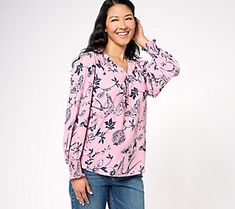 This pullover-style blouse is elevated with a beautiful chinoiserie pattern, while the smocking and ruffle detail along the cuff adds ladylike charm. From Belle by Kim Gravel. Feminine Pink Blouse With Smocked Cuffs, Feminine Tops With Smocked Bishop Sleeves, Feminine Long Sleeve Smock Blouse, Feminine Blouse With Smocked Cuffs, Feminine Tops With Smocked Lantern Sleeves, Feminine Tops With Smocked Cuffs And Lantern Sleeves, Feminine Lantern Sleeve Tops With Smocked Cuffs, Feminine V-neck Tops With Smocked Cuffs, Feminine Smocked V-neck Blouse