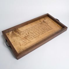 a wooden tray with writing on it