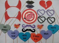 the photo props are arranged on sticks to spell out different words and phrases for valentine's day