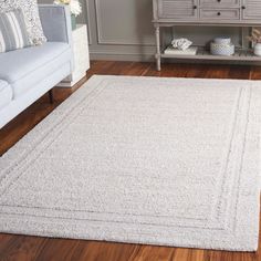 a living room with a white rug on the floor