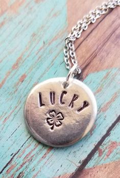 You are one of kind, let your jewelry be the same!These hand formed 7/8 inch pewter pebbles are each totally unique are stamped with "lucky" and a 4 leaf clover.  These necklaces make great and beautiful statements.  Smooth lead free pewter also serves as a great worry stone!.*all items are made to order, colors, fonts and designs may vary. If you want something specific please message me prior to purchase. Adjustable Inspirational Nickel-free Charm Necklace, Inspirational Adjustable Nickel-free Charm Necklaces, Spiritual Engraved Charm Necklace For Good Luck, Spiritual Good Luck Engraved Charm Necklace, Silver Hand Stamped Meaningful Charm Necklace, Meaningful Hand Stamped Sterling Silver Charm Necklaces, Meaningful Hand Stamped Sterling Silver Charm Necklace, Adjustable Stamped Sterling Silver Charm Necklaces, Adjustable Sterling Silver Stamped Charm Necklace