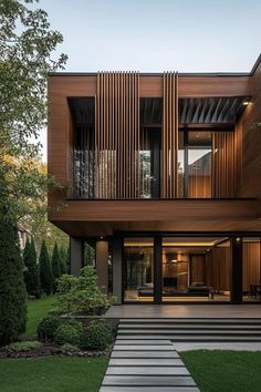 a modern house with wooden sidings and steps leading to the front door