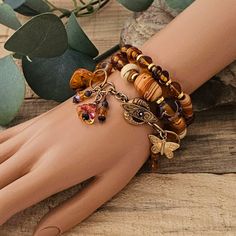 Unique Bohemian handmade bracelets with gorgeous, rare vintage beads. Stunning colors of butterscotch, orange, gold & swirls of cream with vintage acrylic links. Dangles of beads & a beautiful gold butterfly. Two bracelets are on strong, durable stretch cord. The third bracelet has a beautiful brass toggle clasp.  A set of 3 bracelets. Measurement: 7 1/4". Comes in a jewelry box. Boho Hippie Fashion, Bold Bohemian, Hippie Fashion, Bohemian Handmade, Vintage Beads, Bohemian Bracelets, Layered Bracelets, Gold Butterfly, Toggle Clasp