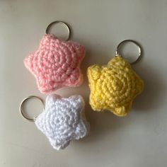 three crocheted star shaped keychains sitting next to each other