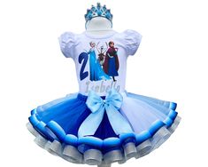 AnitaDressCo store is open as usual. Production takes 1-2 days. Delivery to the USA 2 weeks. I offer you a beautiful birthday tutu outfit. NOTES FOR THE SELLER -Number for personalizing the top. -Name to personalize the vertex. -Need by date. Sleeve for the top - short, long. TOP. The top of it is 100% cotton. Size 3-24 months it is a bodysuit, 2T-10T it is a shirt. (Since it is more handmade always remember the shirt needs to be washed inside out, hand washed and air dried). SKIRT - made of sof Blue Princess Dress For First Birthday, White Princess Dress For Birthday, Girls Party Outfits, Dress Birthday Party, Birthday Tutu Outfit, Silver Birthday, Tutu Costumes, Beautiful Birthday, Dress Birthday