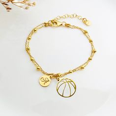 "Wonderful shiny dainty gold  BASKETBALL bracelet with charm set on double chain. It can be personalized by adding initial charm or birthstone. Charm is  smooth and shiny, double sided, is bracelet adjustable, perfect for every women or girl Basketball jewelry: https://www.etsy.com/shop/AnemonAtelier?search_query=basketball ♡ DETAILS  Pendant:12 mm x 14 mm Material; 925 sterling silver or 24k gold plated sterling silver  ( SOLID Sterling Silver 925 from the EU, item has a 925 hallmark) Chain Lenght is Adjustable from 6.5\" to 7.5\" ( 16.5-19.5 cm) ♡ PERSONALISATION  How about adding one of my birthstone pendants  or initial ? Here you can check if your letter is available: https://www.etsy.com/listing/589194296/add-an-initial-charm-personalized-letter?transaction_id=2794459193 The jewelry Basketball Bracelet, Basketball Jewelry, Girl Basketball, Gold Basketball, Personalized Bracelet, Birthstone Pendant, Double Chain, Charm Set, Initial Charm