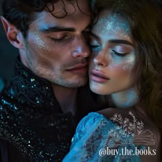 a man and woman with their eyes covered in blue glitters are embracing each other