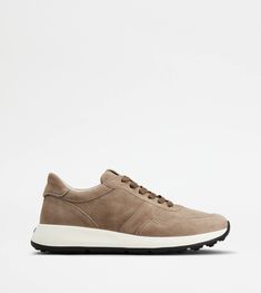 Characterized by an extralight outsole, enriched by the rubber pebble detailing on the back, these sneakers feature a flexible and comfortable construction. The upper, with an elegant and balanced design, is crafted in calfskin suede, with Tod's logo stamped on the tongue. A style that renews the synthesis of artisanal taste, sports inspiration and urban vocation. Classic Leather Running Shoes With White Sole, White Sole Sneakers With Stitched Sole For Walking, Classic Walking Sneakers With Vibram Sole, Modern Leather Running Shoes With Textured Sole, Leather Sneakers With Vibram Sole For Light Sports, Leather Walking Shoes With Vibram Sole For Light Sports, Classic Leather Running Shoes For Light Sports, Leather Running Shoes With Vibram Sole For Light Sports, Leather Running Shoes With Removable Insole For Light Sports