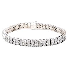 This super sparkly modern diamond tennis bracelet is simply stunning! The multi row design glitters and glows on the wrist, exuding contemporary elegance. Featuring 100 round brilliant diamonds dazzling throughout, the icy white stones really pop against the polished white gold setting. The flexible links offer a comfortable, contoured fit with a secure hinged clasp closure. This bracelet is absolutely breathtaking. Metal: 14K White Gold Natural Diamonds: 10.5 ctw Diamond cut: Round Brilliant Di Bracelet Tennis, Tennis Bracelet Diamond, Brilliant Diamond, Tennis Bracelet, Diamond Clarity, Round Cut Diamond, White Gold Diamonds, Diamond White, Colored Diamonds