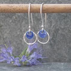 These hoop earrings were handmade from sterling silver and a navy blue enamelled silver disc.  I have hammered the silver hoop to give it added texture and a bit of sparkle. These silver earrings would be a lovely Mothers day gift or Valentines gift.  They are also available in a pale blue colour https://www.etsy.com/uk/listing/627277950/silver-and-enamel-earrings-sterling?ref=shop_home_active_1 although I can make them in the colour of your choice.  Please message me to arrange a different colour if required. You will receive these earrings gift wrapped. Click here to return to Thistledown Wishes home page https://www.etsy.com/uk/shop/ThistledownWishes?ref=seller-platform-mcnav. Click here to see more earrings https://www.etsy.com/uk/shop/ThistledownWishes?ref=seller-platform-mcnav§ion_id Silver Circle Earrings, Long Silver Earrings, Hoop Earrings Silver, Enamel Earrings, Hammered Silver, Enamel Jewelry, Etsy Earrings Dangle, Valentines Gift, Recycled Sterling Silver