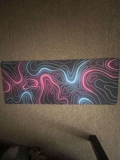 an abstract painting on the wall in a room