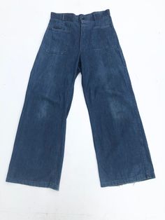 1940s USN denim uniform wide leg trousers have a button front fly, patch hip pockets, and patch back pockets one of which buttons. The stamp on the inside is visible on the right front hip, there's also a name on the inside waist Condition Overall very good with general wear. Has fray along the hems. Has a small light stain above the back right pocket and some fade on the front legs. Measurements Waist 32" Hip 39" Rise 14" Inseam 31" Length 44" Vintage Wide Leg Denim Blue Cargo Jeans, Retro Wide-leg Bottoms With Patch Pockets, Vintage High Waist Denim Cargo Jeans, Retro Wide-leg Denim Cargo Jeans, Vintage High-waist Denim Cargo Jeans, Retro Wide Leg Bottoms With Patch Pockets, Retro Wide Leg Denim Cargo Jeans, Vintage Denim Cargo Jeans With Pockets, Vintage Cargo Jeans With Pockets In Dark Wash