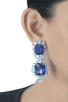 This breath-taking piece is all crafted from sapphire & CZ's. It is wonderfully presented by the sapphire which is beautifully surrounded by the white CZ's of exquisite quality. Try wearing them with your hair pulled back in a sleek ponytail or a bun for a dramatic look. About the Product: Metal: Solid 925 Sterling Silver Stones: Cubic Zirconia Grade: AAAAA Cut: Excellent Clarity: Excellent Why Buy from Adastra? 1. The USA patented 925 Sterling Silver, making each creation last for decades. 2. E Halo Jewelry, Cushion Halo, Princess Ring, Sleek Ponytail, Heritage Fashion, Sapphire Earrings, Wedding Wear, Silver Wedding, Solid 925 Sterling Silver