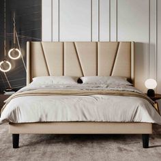 a bed with white sheets and pillows in a modern style bedroom, next to a lamp on the wall