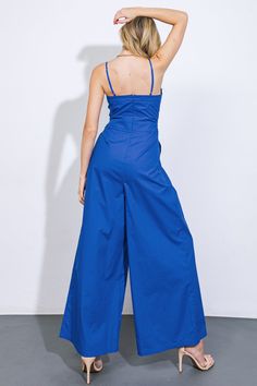 A solid woven jumpsuit featuring scalloped bodice edge, shoulder strap, button down, pleated front pant, wide leg and back zipper closureDetails:Self : 100% CottonSize & Fit- Model is 5`8" And Wearing Size Small- Measurements Taken From Size Small- Approx. Length: 60" Solid Color Summer Jumpsuits And Rompers With Wide-leg Pants, Summer Wide-leg Jumpsuits And Rompers In Solid Color, Fitted Wide Leg Jumpsuit Or Romper In Solid Color, Summer Solid Color Wide-leg Jumpsuits And Rompers, Solid Color Summer Jumpsuits With Wide-leg Pants, High Waist Overalls For Spring, Strapless Jumpsuit With Pockets For Spring, Chic Blue Wide-leg Jumpsuits And Rompers, Chic Blue Wide Leg Jumpsuits And Rompers