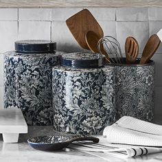 kitchen utensils in blue and white canisters