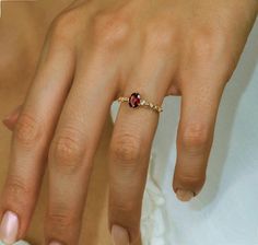 a close up of a person's hand with a ring on it