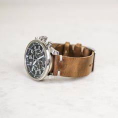 "Our classic 2-piece custom leather watch straps feature Horween Leather in multiple color options with natural stitching. Straps feature a thumbnail style buckle and leather strap stays. As you wear your strap, you will notice how quickly it breaks in and molds to your wrist creating an incredibly comfortable fit. And with daily wear, it will deepen in color and patina becoming a piece completely unique to you. * Handmade watch band in Horween Leather * Unlined and unfinished edges * Simple sti Timeless Leather Strap Watch Accessories For Everyday Use, Classic Watch Bands With Waxed Finish For Everyday Use, Timeless Watch Bands With Bracelet Strap For Daily Use, Timeless Bracelet Strap Watch Bands For Everyday Use, Leather Bracelet Strap For Everyday Watch Use, Timeless Watch With Bracelet Strap For Everyday, Adjustable Leather Watch With Stainless Steel Clasp, Timeless Watches For Everyday Use, Leather Watch Accessories With Subdials For Everyday