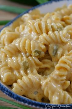 a bowl filled with macaroni and cheese on top of a table