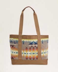 Elevate your travels or daily commute with our Highland Peak Zip Tote. Designed with a roomy zip-top and crafted with wool jacquard from our Pacific Northwest mills, this tote exudes distinctive style. The polyester canvas trim and leather handles add a touch of luxury, while the interior slip pocket provides practicality. Each piece is unique with varying pattern placements, making it truly one-of-a-kind. Loving the Highland Peak Design? Check out the matching backpack & crossbody bag. Highland Leather Trim Tote Shoulder Bag For Overnight Trips, Winter Travel Brown Shoulder Bag, Wool Tote Bag For Travel, Fall Beige Shoulder Bag With Leather Trim, Wool Travel Bags For Fall, Wool Tote Bag For Daily Use, Daily Use Wool Tote Bag, Canvas Shoulder Bag With Leather Handles For Overnight Trips, Canvas Tote Shoulder Bag For Overnight Trips