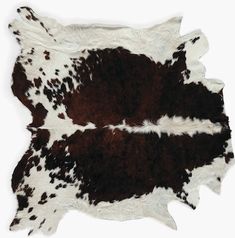 two brown and white cowhide rugs laying on top of each other