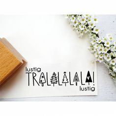 a rubber stamp with the word justig trailland written in black on it next to some flowers