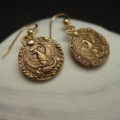 Handmade antiqued dainty birthday gift Scorpio earrings. This charm has the phoenix protecting the Scorpio.Handmade antiqued bronze coin charm with the zodiac sign of Scorpio for people born between October 24 to November 22.Scorpio are: Resourceful, Brave, Passionate, Stubborn, True Friend.The concept of the zodiac originated in Babylonian astrology, and was later influenced by Hellenistic culture. According to astrology, celestial phenomena relate to human activity on the principle of "as abov Gold Earrings With Antique Finish For Gift, Antique Gold Coin-shaped Jewelry With Antique Finish, Antique Finish Copper Earrings As Gift, Antique Finish Coin-shaped Brass Jewelry, Symbolic Bronze Jewelry With Antique Finish, Bronze Symbolic Jewelry With Antique Finish, Symbolic Antique Gold Medallion Jewelry, Symbolic Antique Bronze Jewelry, Brass Medallion Earrings As A Gift