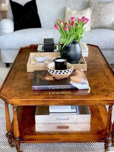 a coffee table with flowers and books on it