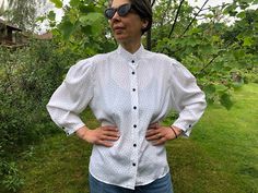 Vintage 80s white black polka dot blouse. Mutton sleeve, front buttoned blouse. Stand up collar. Made of silky, flowing polyester fabric. Beautiful women's clothing.  To fit size L  From shoulder to shoulder  16" 41cm Bust  47" 119cm Sleeve length  19,5" 49cm Length  24"  61cm Retro Fitted Polka Dot Blouse, Fitted Button-up Blouse With Polka Dot Pattern, Fitted Polka Dot Button-up Blouse, Vintage Polka Dot Blouse For Work, Vintage Polka Dot Blouse For Workwear, Chic Polka Dot Blouse With Buttons, Classic Fitted Polka Dot Blouse, Fitted Polka Dot Blouse For Work, Elegant Polka Dot Top With Buttons