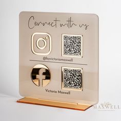 a white and gold plaque with qr - code on it that says connect with us