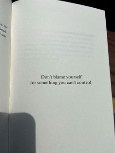 an open book with the words don't blame yourself for something you can't control