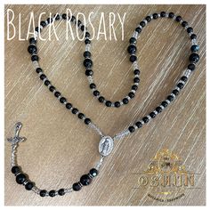 Black Rosary made out of 6/0 Czech and glass beads with gold cross and pendant. Black Faceted Spiritual Beads, Black Spiritual Rosary Bracelet With Cross, Black Beaded Cross Rosary, Adjustable Black Rosary With Cross, Black Beaded Cross-shaped Rosary, Adjustable Black Cross Rosary, Black Crucifix Rosary Bracelet As Gift, Handmade Black Cross Rosary Bracelet, Black Rosary