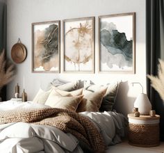 a bedroom with three paintings hanging on the wall above the bed and two pillows in front of it