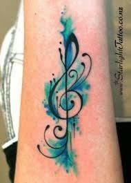 a blue and green tattoo with musical notes on it