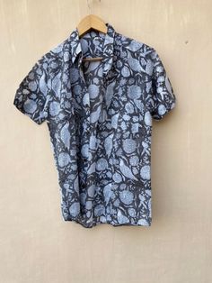 "100% Cotton Hand Block Print Shirt is very soft and made with very fine stitching. It is very comfortable in summer and in night . Both Men,s and Women's can wear. Fabric is 100% cotton and printing is traditional by hand block. Colour is very fast . It can wash hand or machine both in cold water. SIZE : M : Length 27\"( 67.5 cms) Chest 38\" ( 95 cms) Shoulder 17\" ( 42.5 cms) Sleeve 8\" ( 20 cms.) L: Length 28\"( 70 cms) Chest 40\"( 100cms) Shoulder 18 ( 45cms) Sleeve 8.5\"( 21.25cms.) XL: Len Collared Cotton T-shirt For Beach, Cotton Block Print Relaxed Fit Top, Cotton Block Print Tops With Relaxed Fit, Collared Cotton T-shirt For The Beach, Collared Cotton Beach T-shirt, Black Block Print Cotton Tops, Blue Block Print Short Sleeve Top, Casual Blue Block Print Tops, Blue Short Sleeve Tops With Block Print