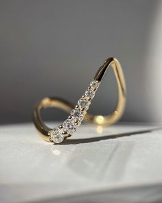 a diamond ring sitting on top of a table