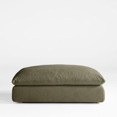 an olive green linen pillow on a white background