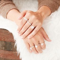 two hands holding each other on top of a white furnishing area with three rings in the middle