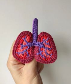 a crocheted human's lungs is shown in purple and red