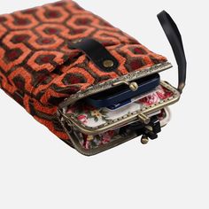 With a nod to the Victorian era, MCW’s freshly combines the classic and elegant design of the traditional carpet bag with a textural and tactile twist.The main body of the functional phone case is made with rich chenille carpet, cotton floral canvas, and brass clasp with double kiss lock. With the width 4.15" and height 8.60" it can easily hold phones of any sizes (max phone width to 4"), with the leather wrist strap that comes with the bag. There are two mini rings at both sides of the clasp an Vintage Phone Bag With Removable Pouch For Travel, Vintage Travel Phone Bag With Removable Pouch, Vintage Phone Bag With Removable Pouch, Vintage Rectangular Phone Bag With Removable Pouch, Vintage Phone Bag For Travel, Vintage Phone Bag With Cell Phone Pocket For Travel, Vintage Travel Phone Bag With Cell Phone Pocket, Overlook Hotel Carpet, Victorian Carpet