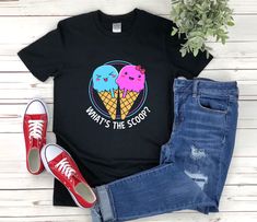 "* All shirts are unisex. * Product measurements may vary by up to 2 inches. * All Designs are originally made by myself or my team.  Gender Reveal shirt with the quote \"Whats The Scoop\" is a fun gift for men and women!  To see more designs of your topic Gender Reveal you can search & find them in the store:   https://www.etsy.com/shop/Retailorie  You find there also an announcement if the shipping & production times change :) whats the scoop,ice cream theme,boy or girl shirt,team blue shirt,team pink shirt,gender reveal shirt,baby shower shirts,baby announcement,baby reveal shirts,gender reveal party,pregnancy shirt,pregnancy reveal,gender reveal gift," Novelty Summer Tops With Cartoon Print, Novelty Cartoon Print Summer Tops, Summer Novelty Tops With Cartoon Print, Novelty Character Print Tops For Summer, Funny Black Tops For Gender Reveal, Short Sleeve T-shirt For Gender Reveal In Summer, Novelty Short Sleeve Shirt With Cartoon Print, Short Sleeve Tops For Summer Gender Reveal, Summer Short Sleeve Tops For Gender Reveal