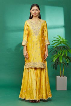 Yellow kurta with floral hand embroidery. Paired with embroidered sharara and organza dupatta.
Component: 3
Pattern: Embroidered
Type Of Work: Floral
Neckline: Round
Sleeve Type: Three Quarter
Fabric: Kurta and Sharara: Pure spun silk, Dupatta: Organza
Color: Yellow
Other Details: 
Floral hand embroidery
Organza dupatta
Occasion: Wedding - Aza Fashions Semi-stitched Slub Silk Sets With Dori Work, Designer Raw Silk Palazzo Set For Transitional Season, Designer Resham Embroidery Sharara For Diwali, Designer Raw Silk Palazzo Set With Resham Embroidery, Designer Raw Silk Sharara With Gota Work, Gold Embroidered Sharara In Slub Silk, Designer Wear Dola Silk Sharara With Zari Work, Semi-stitched Raw Silk Set With Gota Work, Transitional Raw Silk Sharara With Zari Work